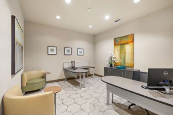 An office with a desk and chairs and a computer